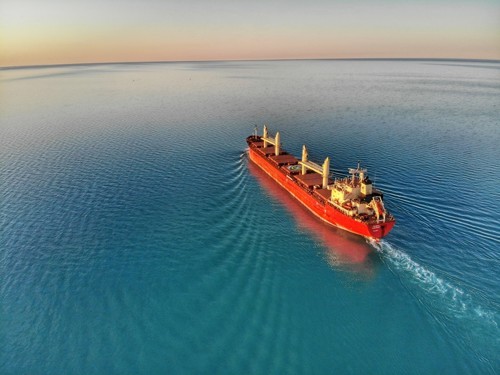 Photograph of a red ship at sea