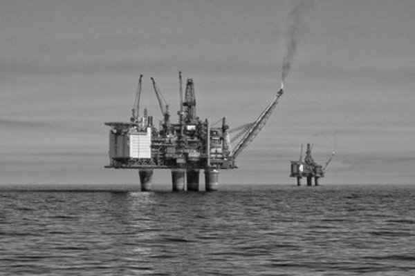 Black and white photo of an oil rig.